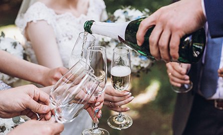 Group at a wedding pouring wine